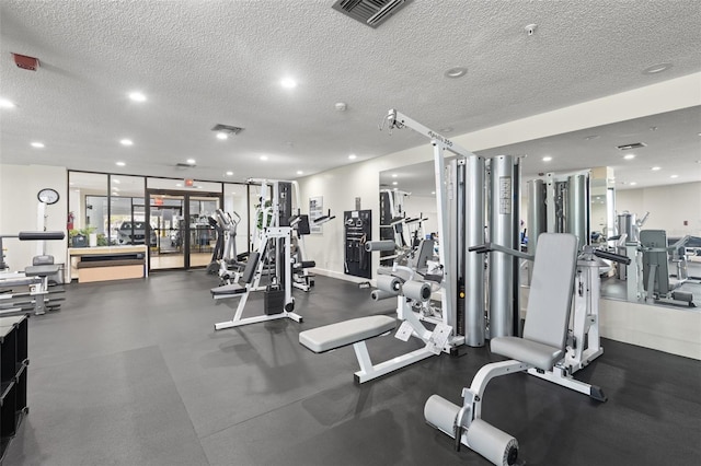 exercise room featuring a textured ceiling