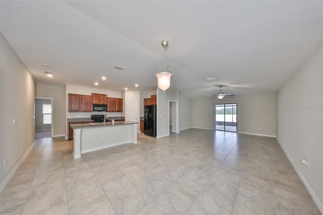 kitchen featuring black appliances, decorative light fixtures, sink, a kitchen island with sink, and ceiling fan