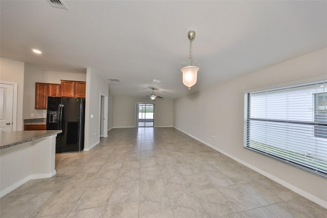 kitchen featuring black refrigerator with ice dispenser, pendant lighting, light tile patterned floors, and ceiling fan