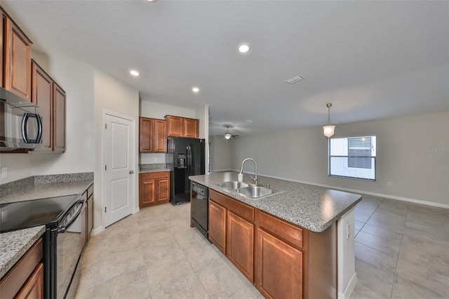 kitchen featuring ceiling fan, sink, decorative light fixtures, a center island with sink, and black appliances