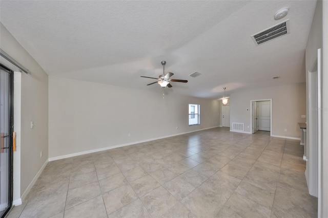 tiled empty room featuring ceiling fan