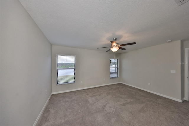 carpeted empty room featuring a textured ceiling and ceiling fan