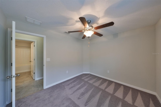 spare room with ceiling fan and light colored carpet