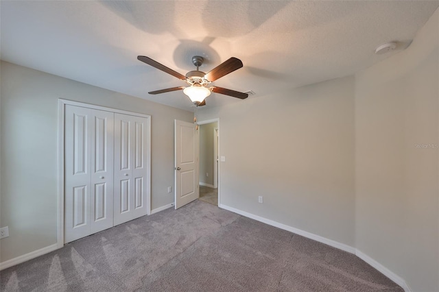 unfurnished bedroom with a closet, ceiling fan, and light carpet