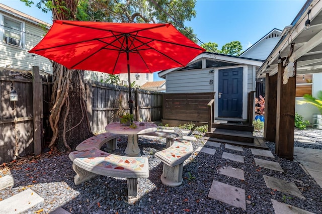 view of patio featuring a storage unit