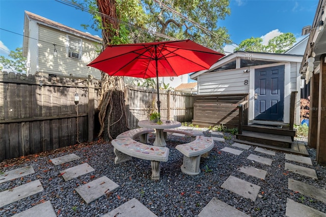 view of patio / terrace featuring a storage unit