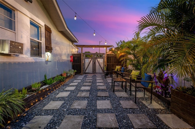 patio terrace at dusk featuring cooling unit