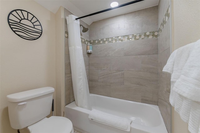 bathroom with shower / bath combo with shower curtain and toilet