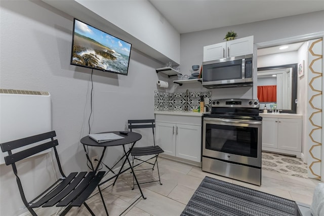 kitchen featuring white cabinetry, light tile patterned floors, and stainless steel appliances