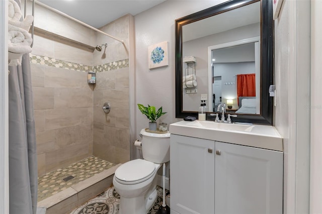 bathroom featuring vanity, tile patterned floors, toilet, and walk in shower