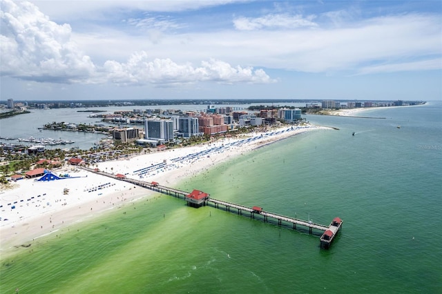 drone / aerial view featuring a water view and a view of the beach