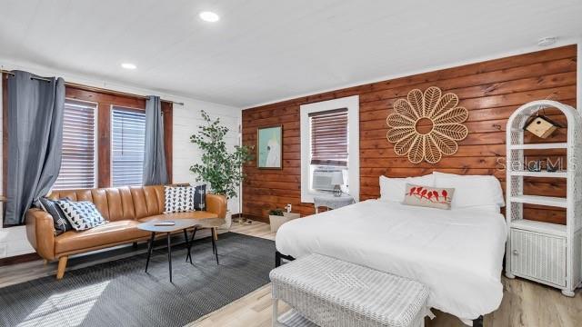 bedroom featuring hardwood / wood-style floors and cooling unit