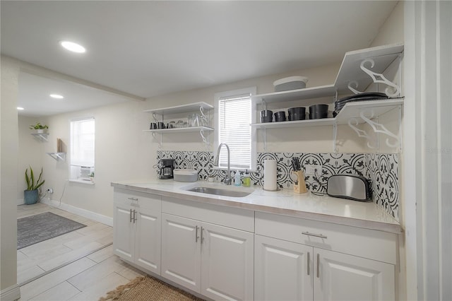 kitchen featuring white cabinetry and sink