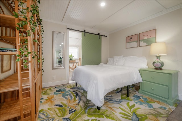 bedroom featuring ornamental molding and a barn door