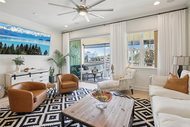 living room featuring ceiling fan, wood-type flooring, and ornamental molding