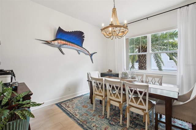 dining room with wood-type flooring and an inviting chandelier