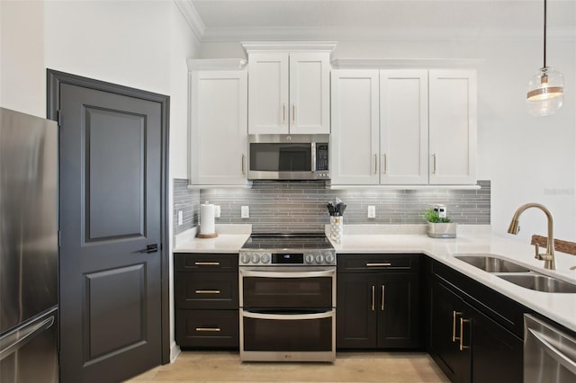 kitchen with appliances with stainless steel finishes, sink, and white cabinetry