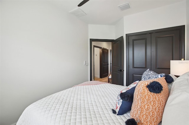 bedroom with ceiling fan and a closet