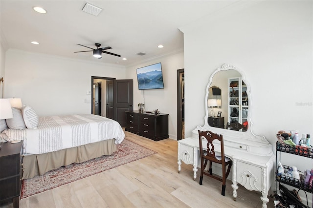 bedroom with ceiling fan, light hardwood / wood-style floors, and ornamental molding