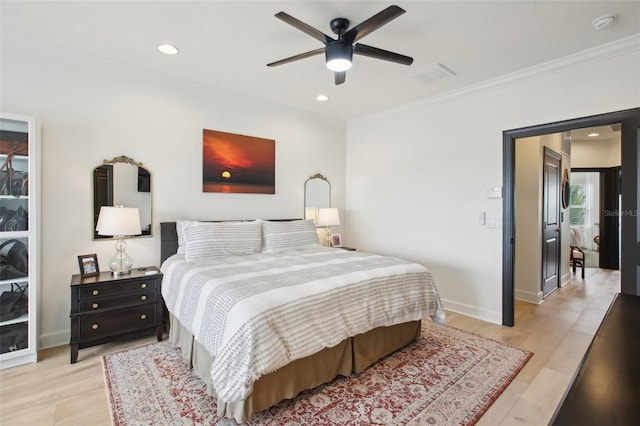 bedroom with ceiling fan, ornamental molding, and light hardwood / wood-style floors