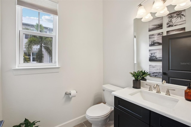 bathroom with toilet and vanity