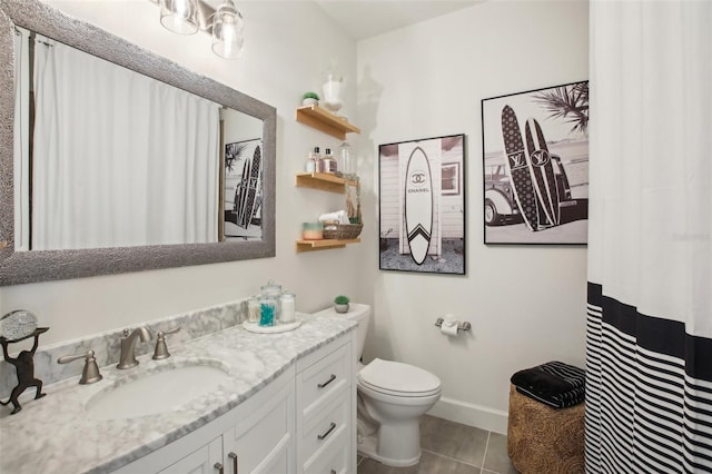 bathroom with tile patterned floors, vanity, and toilet