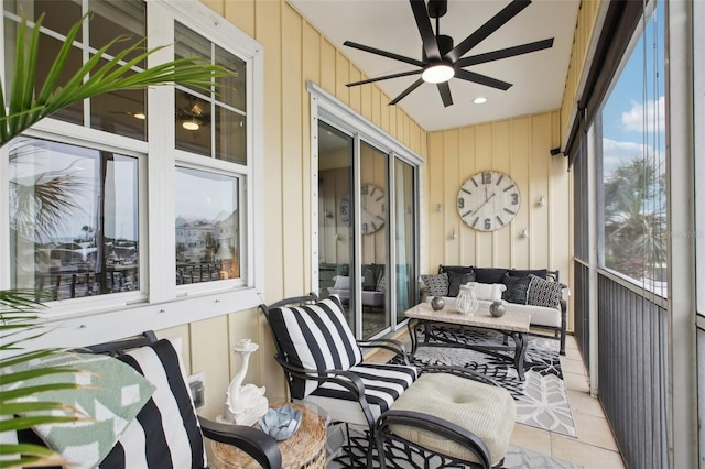 sunroom featuring ceiling fan