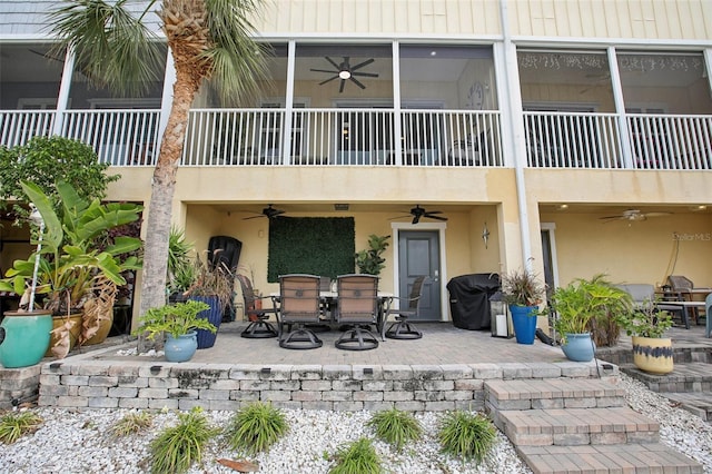 back of house featuring a balcony and a patio area