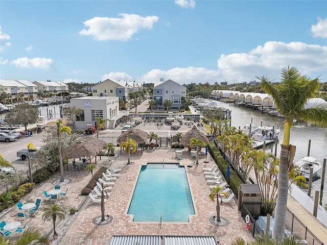 view of pool featuring a patio area and a water view