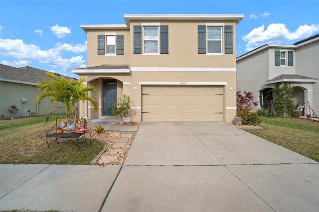 view of front of home with a front yard and a garage