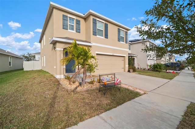 view of front of home with a front yard and a garage