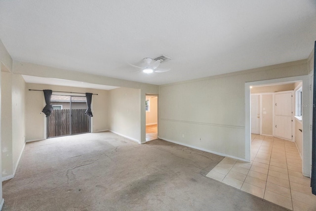 spare room with ceiling fan, ornamental molding, and light carpet