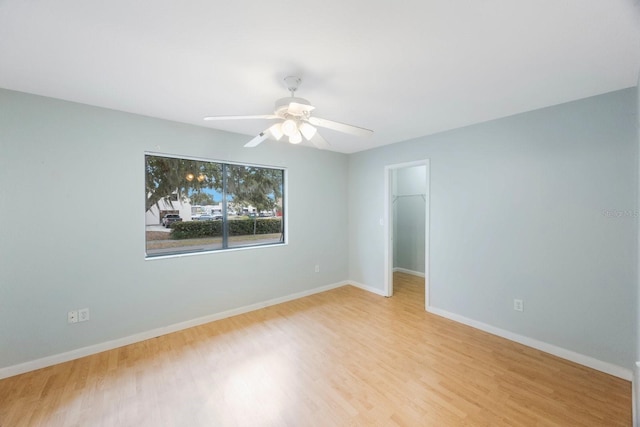 empty room featuring ceiling fan and light wood-type flooring