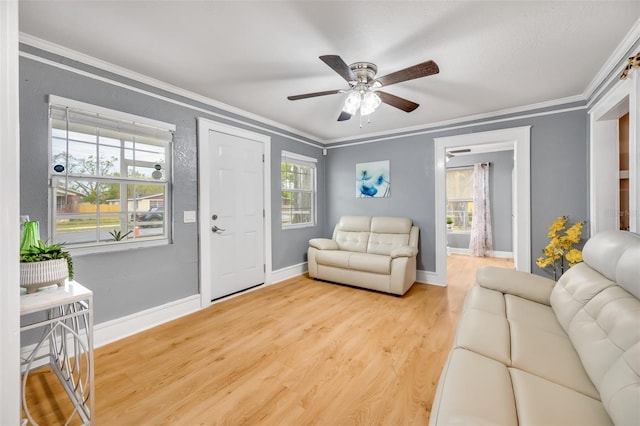 living room with ornamental molding, ceiling fan, and wood-type flooring