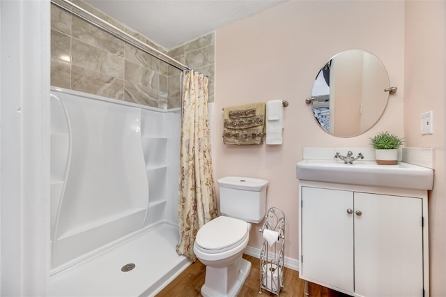 bathroom with vanity, hardwood / wood-style flooring, curtained shower, and toilet