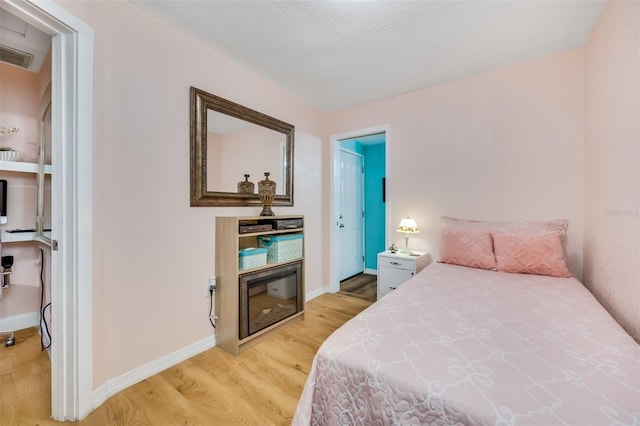 bedroom with light hardwood / wood-style floors