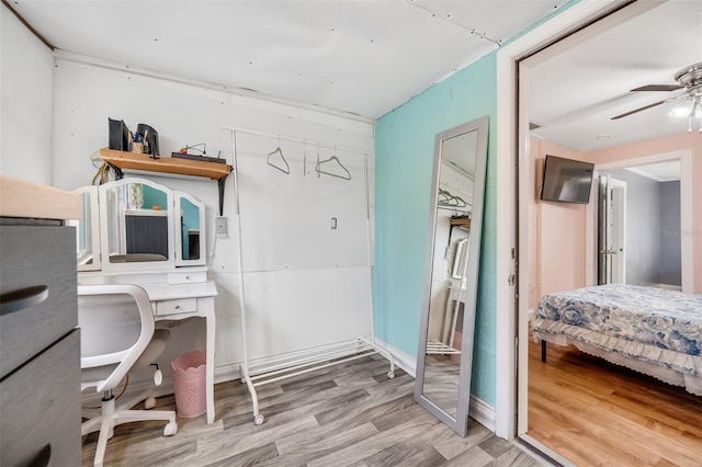 home office featuring ceiling fan and light hardwood / wood-style floors