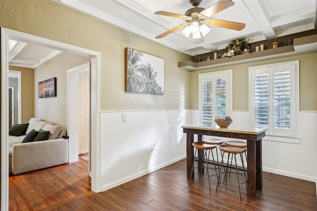 dining room with coffered ceiling, ceiling fan, dark hardwood / wood-style flooring, ornamental molding, and beamed ceiling