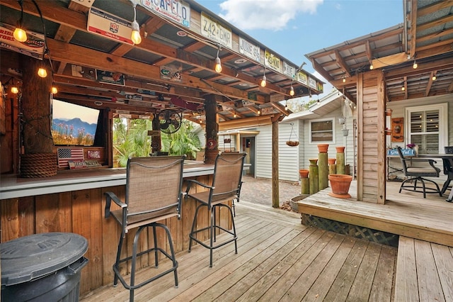 deck at dusk with exterior bar