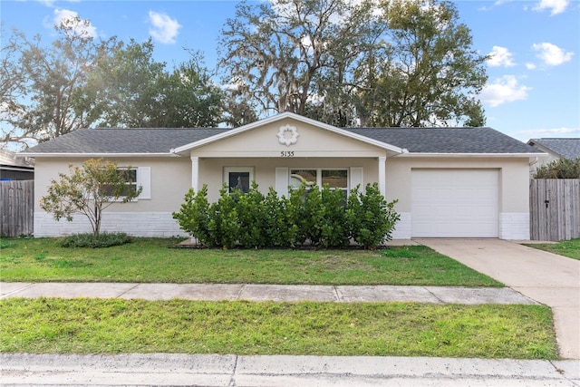 single story home with a garage and a front lawn