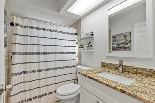 bathroom featuring toilet and vanity