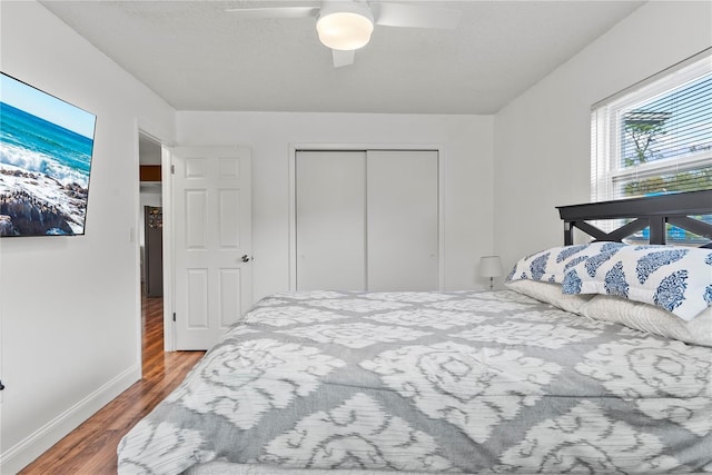 bedroom with a closet, ceiling fan, and hardwood / wood-style floors