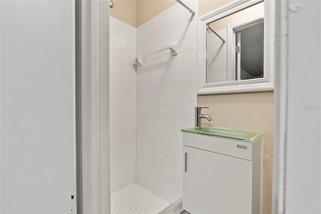 bathroom featuring vanity and a tile shower