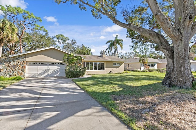 ranch-style home with a front lawn and a garage