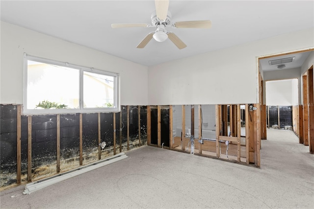 unfurnished room with ceiling fan and a baseboard radiator