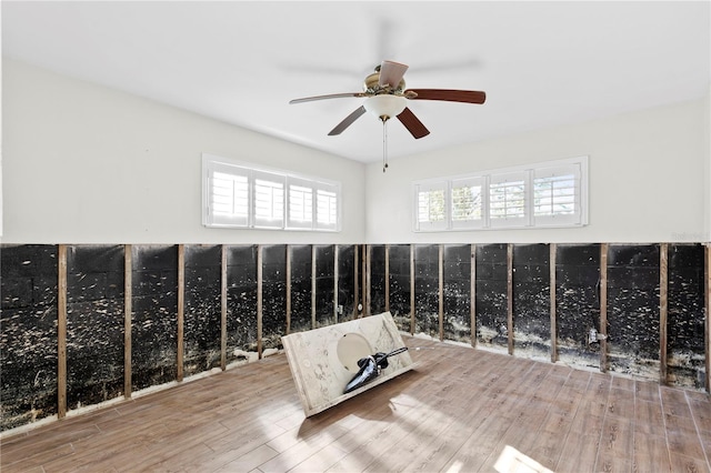 interior space with ceiling fan and wood-type flooring