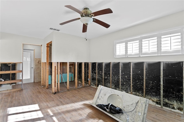 interior space with ceiling fan and hardwood / wood-style floors