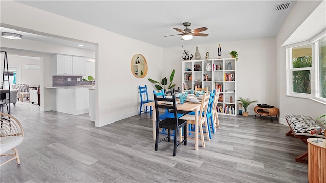 dining space featuring ceiling fan, light wood-type flooring, and plenty of natural light