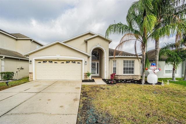 ranch-style house featuring a garage and a front lawn