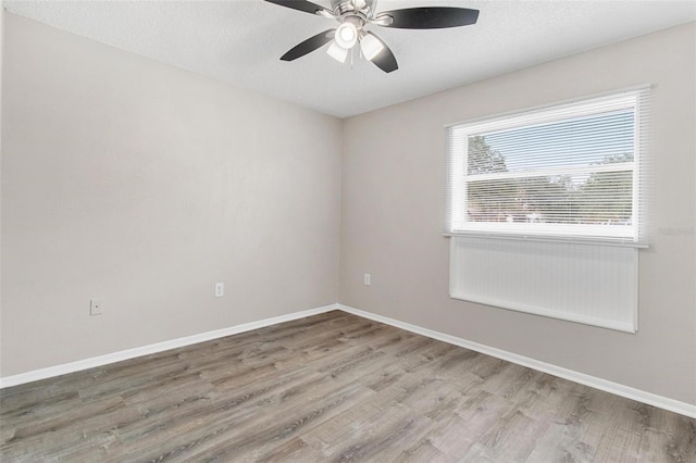 unfurnished room with a textured ceiling, ceiling fan, and hardwood / wood-style flooring